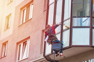 industrial-climber-cleaning-window-on-building-in-city